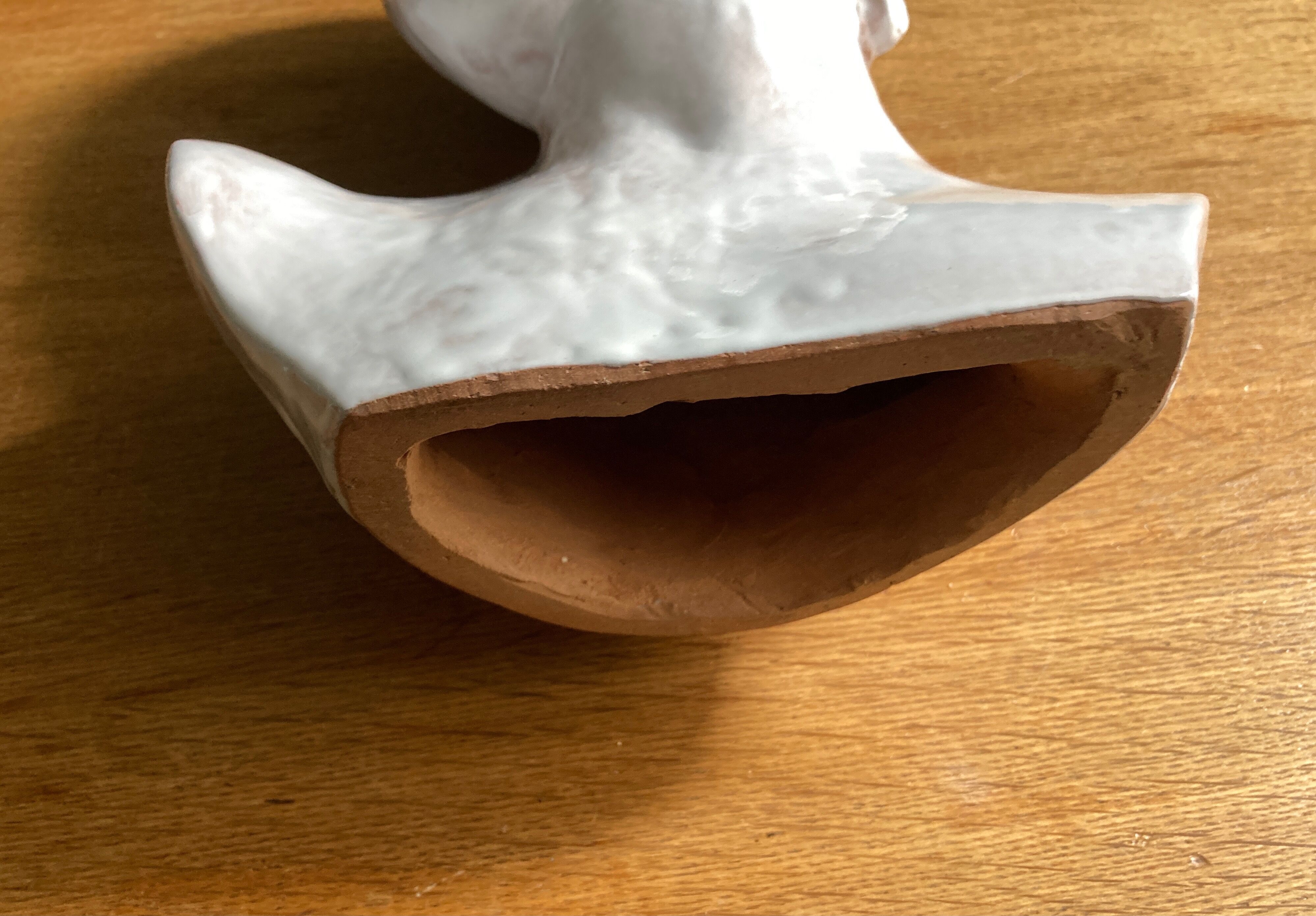 White enamelled terracotta Eros bust