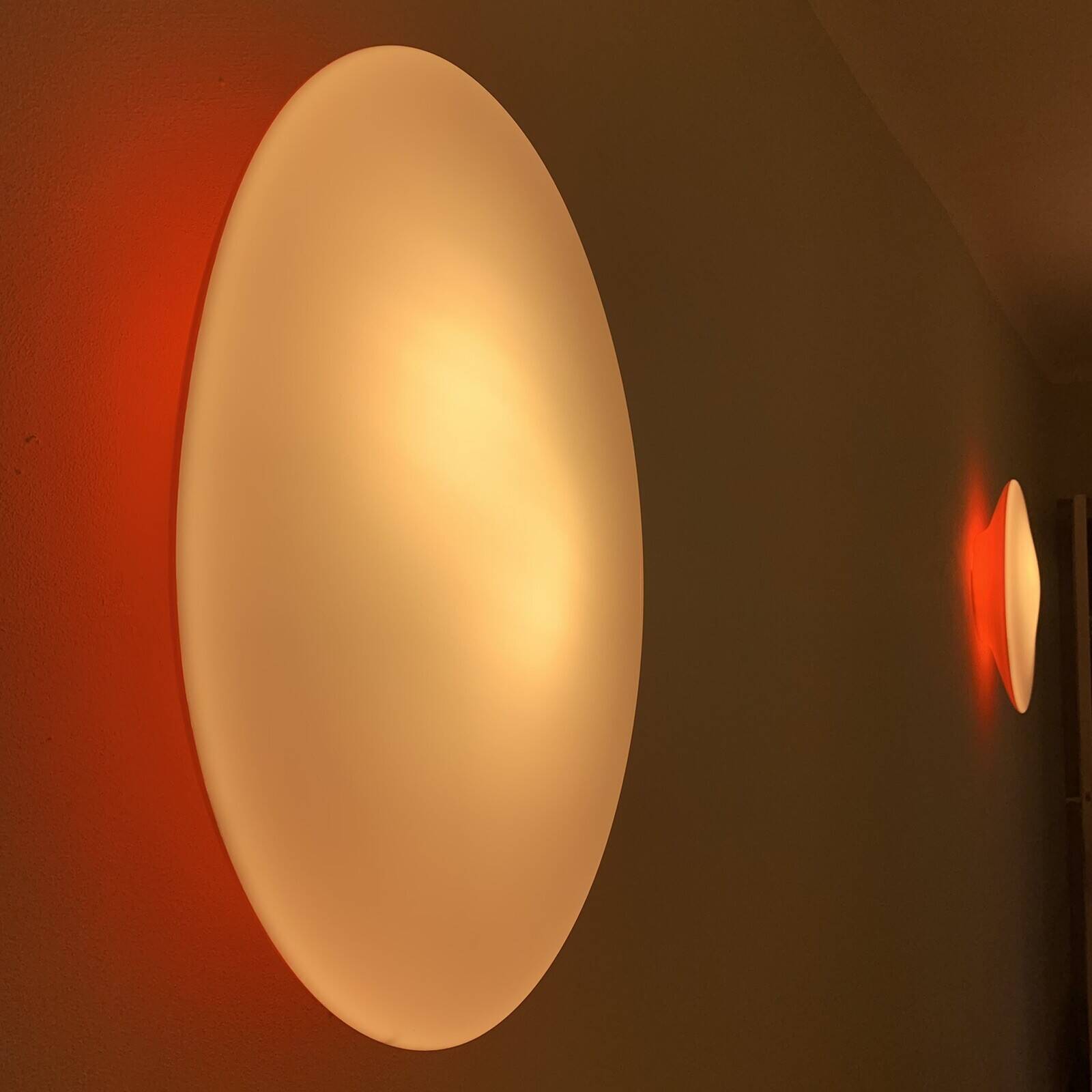 Oval wall lamp Artemide Italy design Patrick Jouin orange and white.