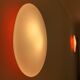 Oval wall lamp Artemide Italy design Patrick Jouin orange and white.