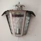Half grey metal wall sconce and 3 windows