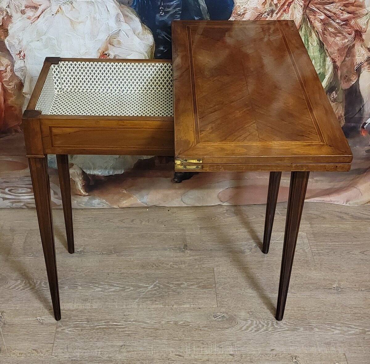 Louis XVI period game table in mahogany and marquetry.