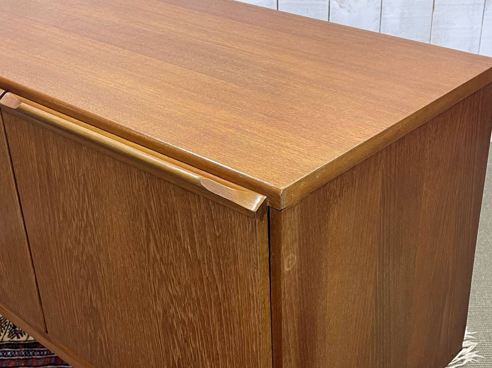 1970s English enfilade in teak with splayed legs.