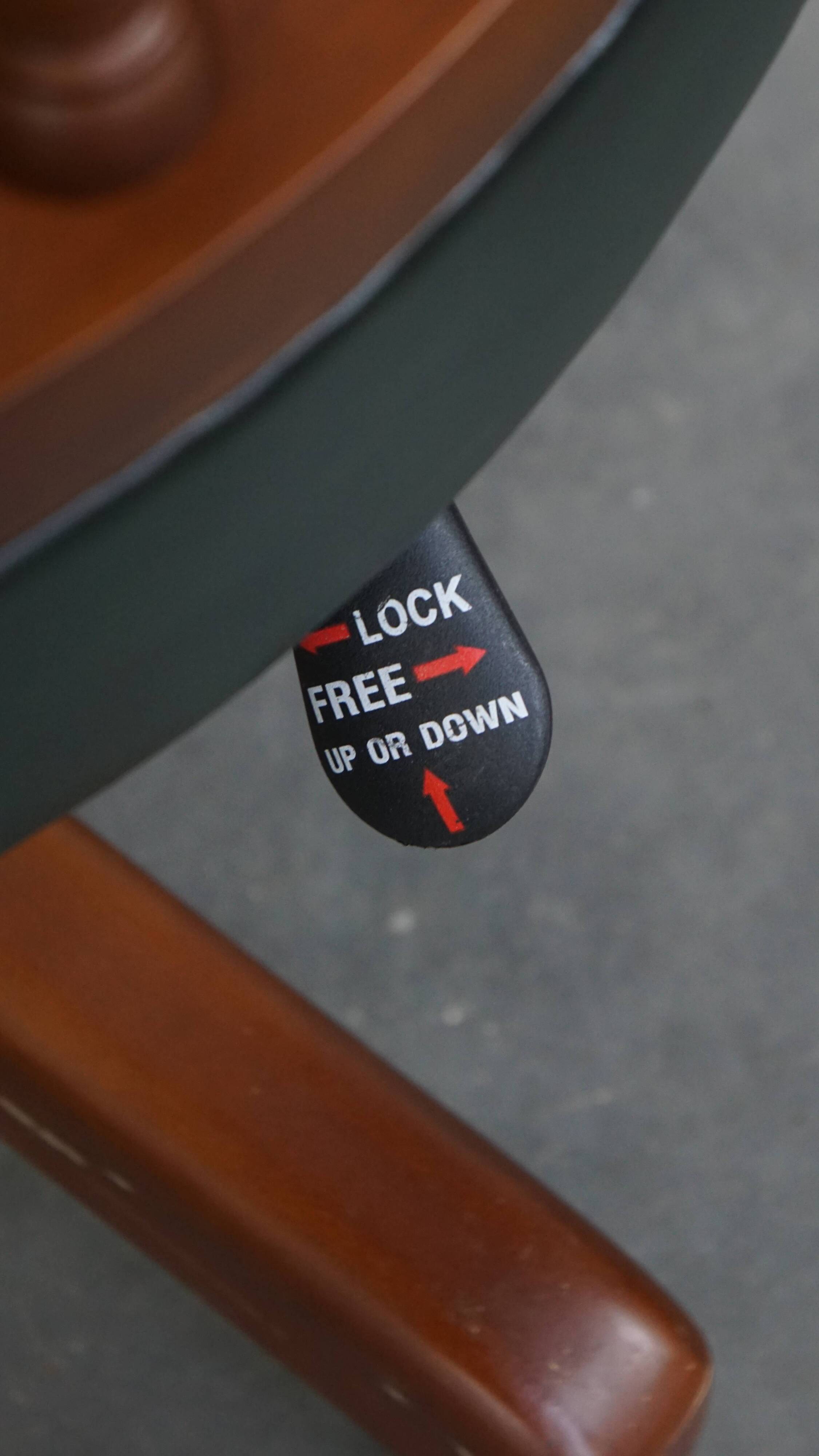 Dark green chesterfield office chair in cowhide leather on wheels