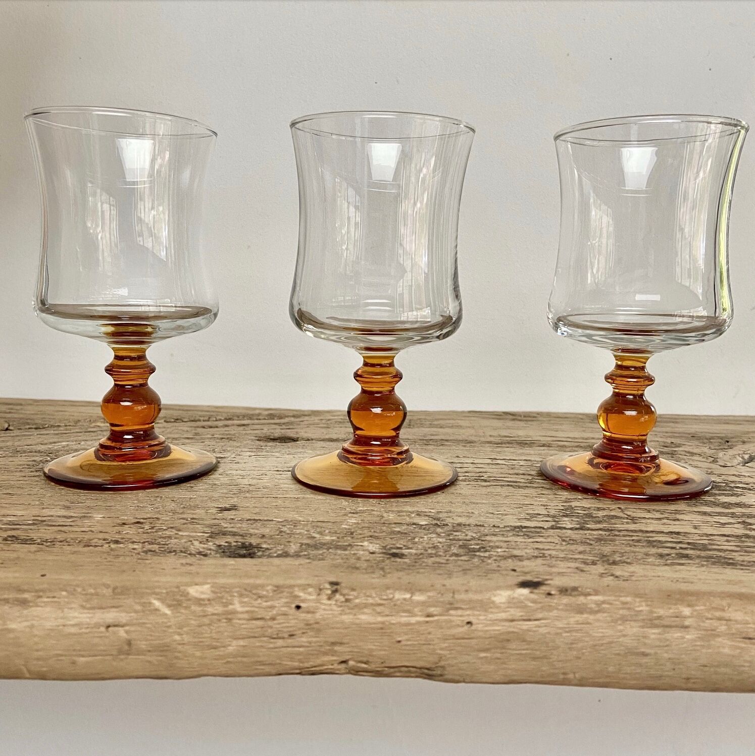 6 small amber-stemmed glasses