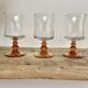 6 small amber-stemmed glasses