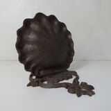 Old cast iron planter shell-shaped plant support