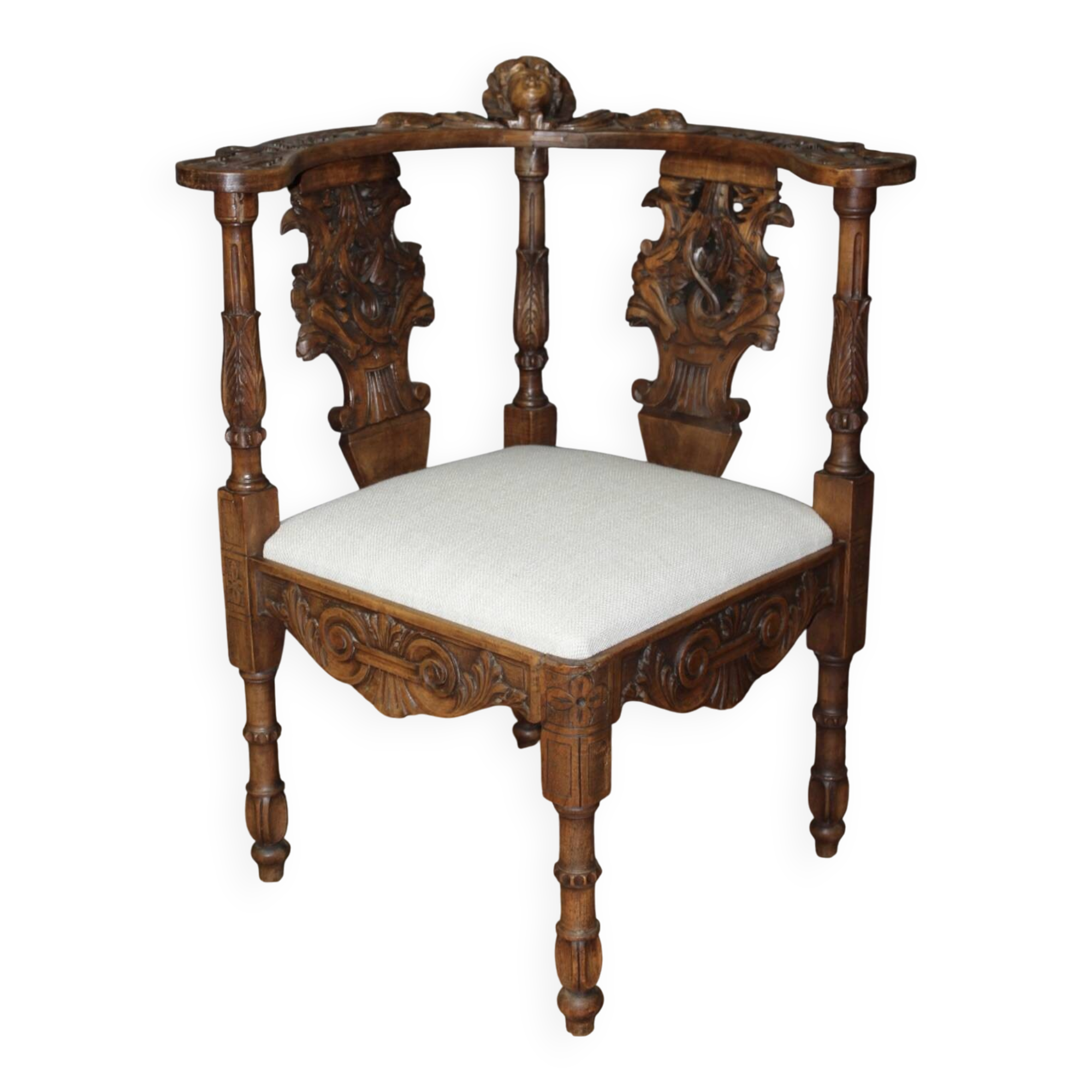 19th century walnut corner armchair with carved angel decoration