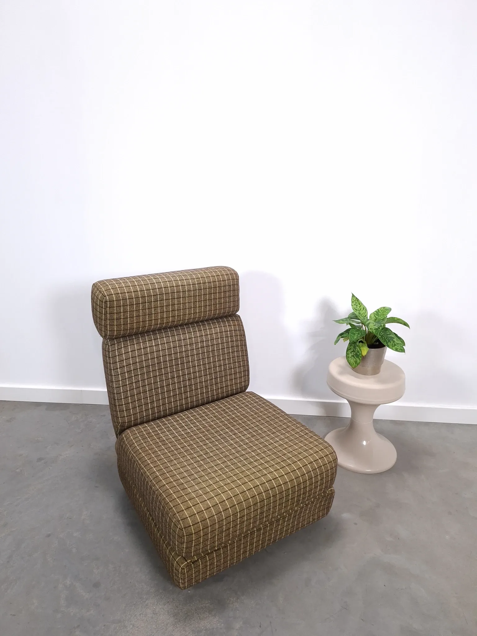 Vintage pull-out sofa bed, brown checked lounge chair with chrome.