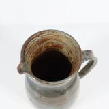 Handcrafted stoneware pitcher with blue-green hues, signed piece