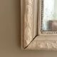 Antique Louis-Philippe mirror with pearls and shells, white patina.