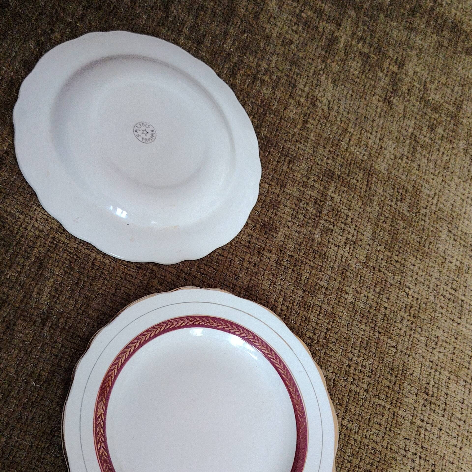 Salins white ceramic dessert plates with red trim and gold rim.