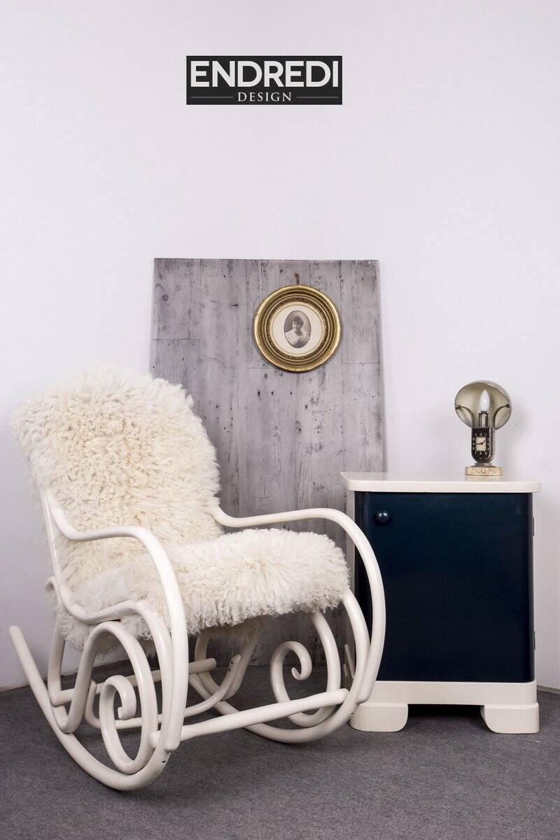 Antique Thonet rocking chair in ivory lacquered bent wood, with a white lamb fur seat.