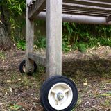 Vintage wooden garden bench with wheels