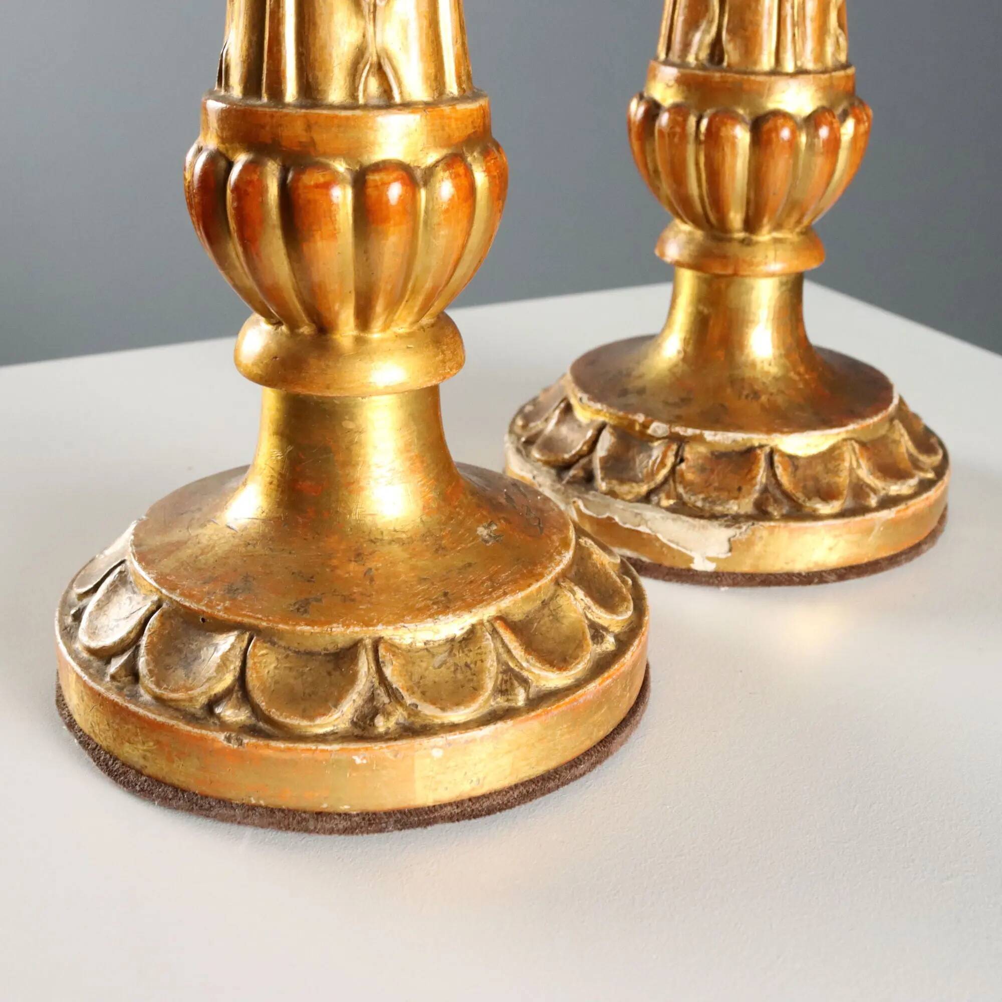 Pair of antique carved and gilded wooden candlesticks, Italy, 19th century.