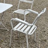 Garden furniture in wrought iron and wooden slats composed of two armchairs, 4 chairs and a table.