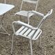 Garden furniture in wrought iron and wooden slats composed of two armchairs, 4 chairs and a table.