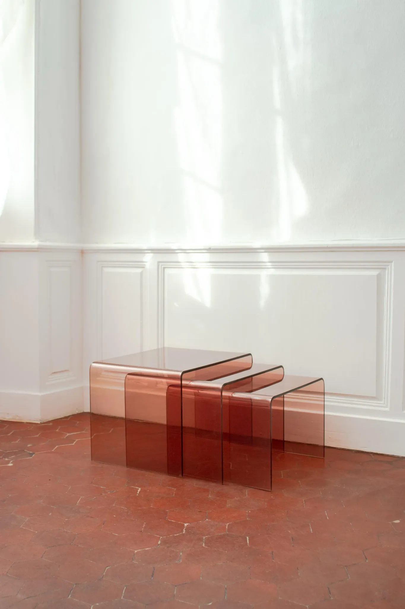Vintage trio of nesting tables in smoked plexiglass by Michel Dumas, year