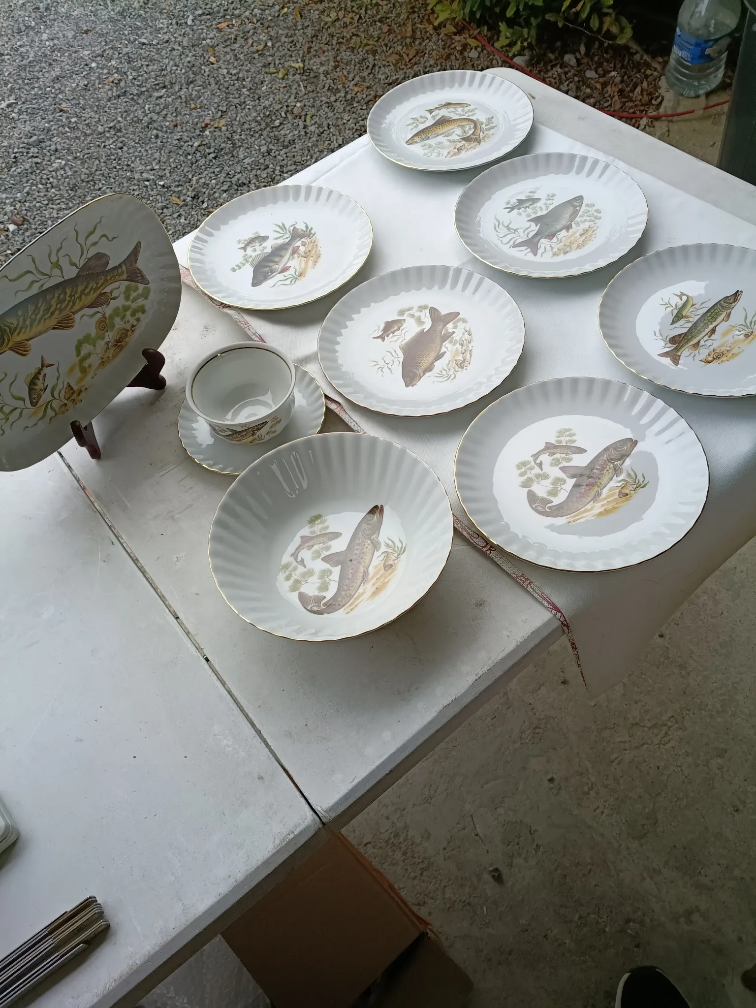 vintage porcelain dinner service with fish pattern and gold trim