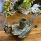 Hand candlestick, peacock shape, in bronze