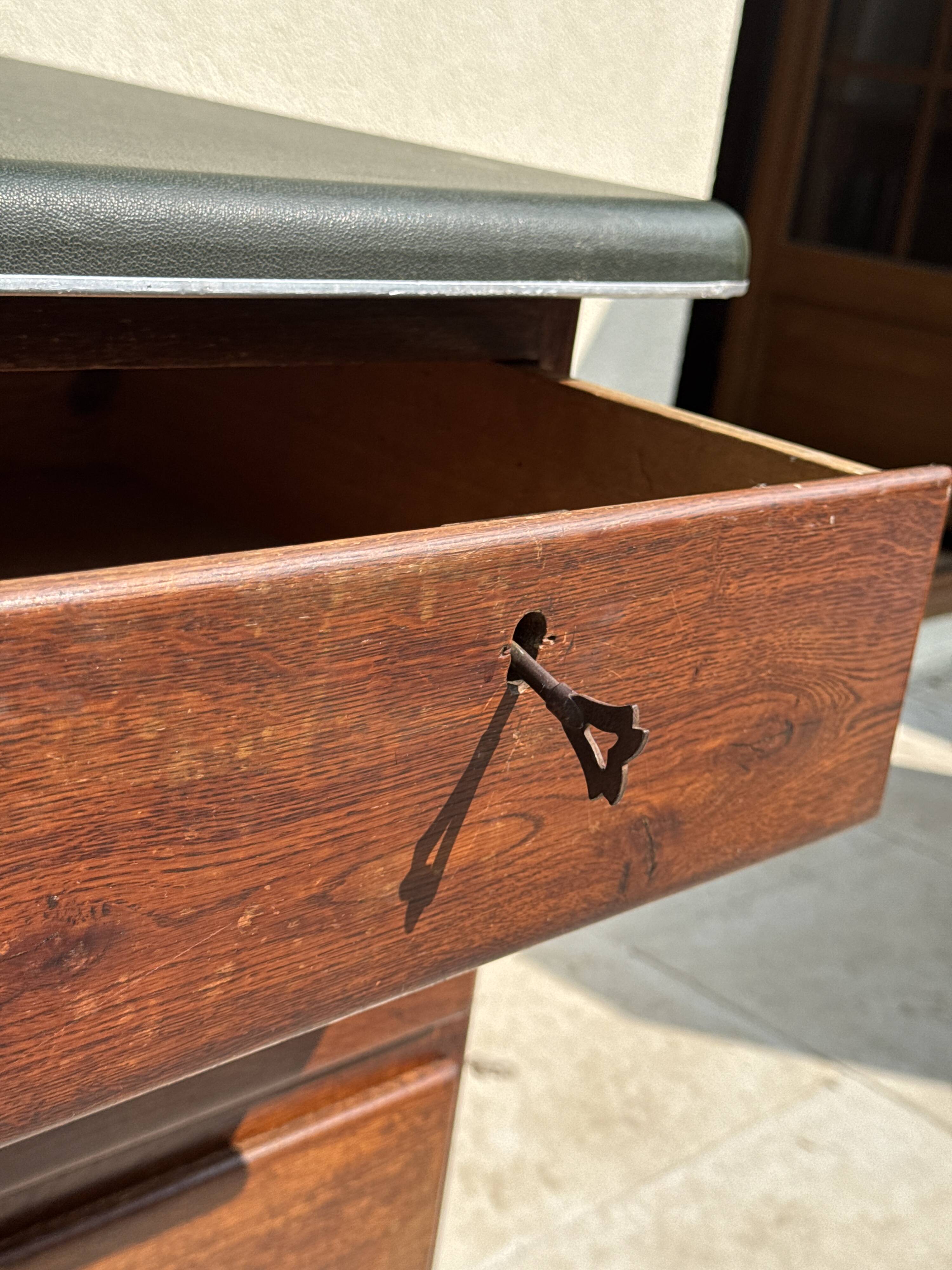 Modernist desk in wood and green moleskin upholstery
