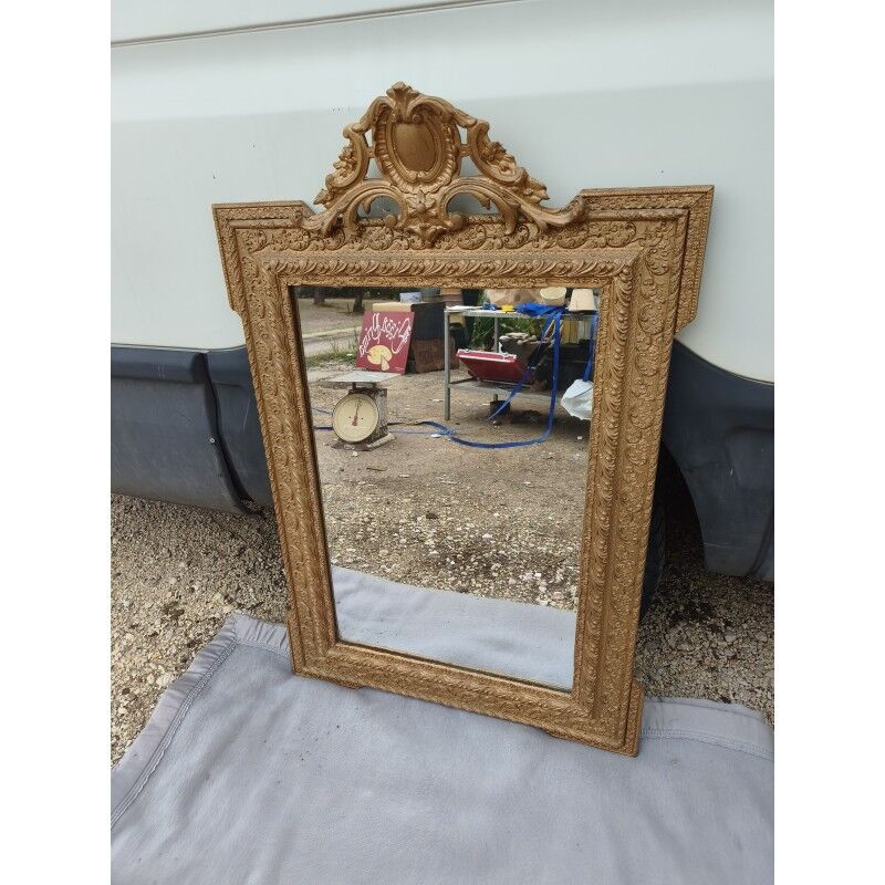 19th-century mirror in gilded wood and stucco.
