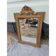 19th-century mirror in gilded wood and stucco.