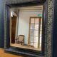 19th-century mirror Napoleon III in blackened wood on a gold background.