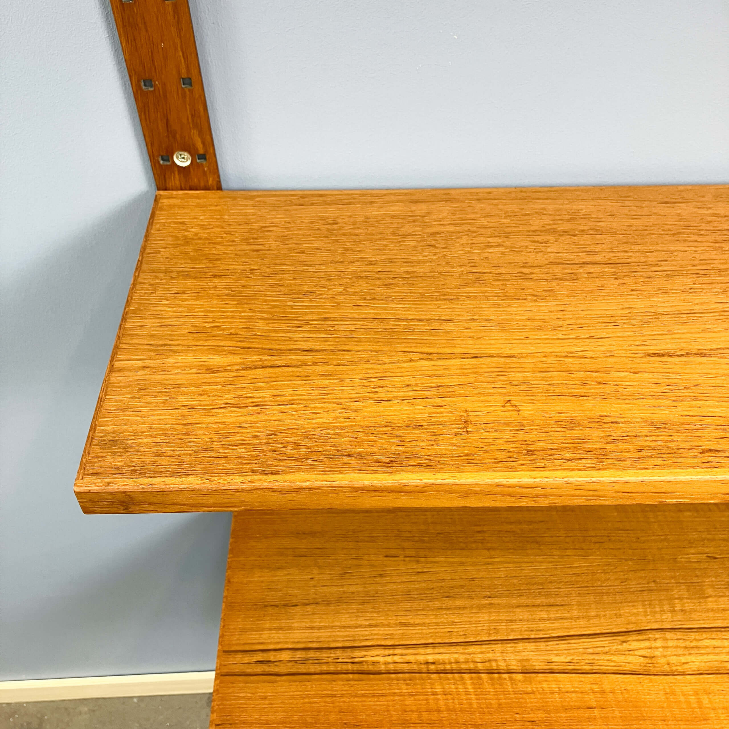 Danish wall shelf by Hansen and Guldborg, teak, aluminum rails, 1960s.