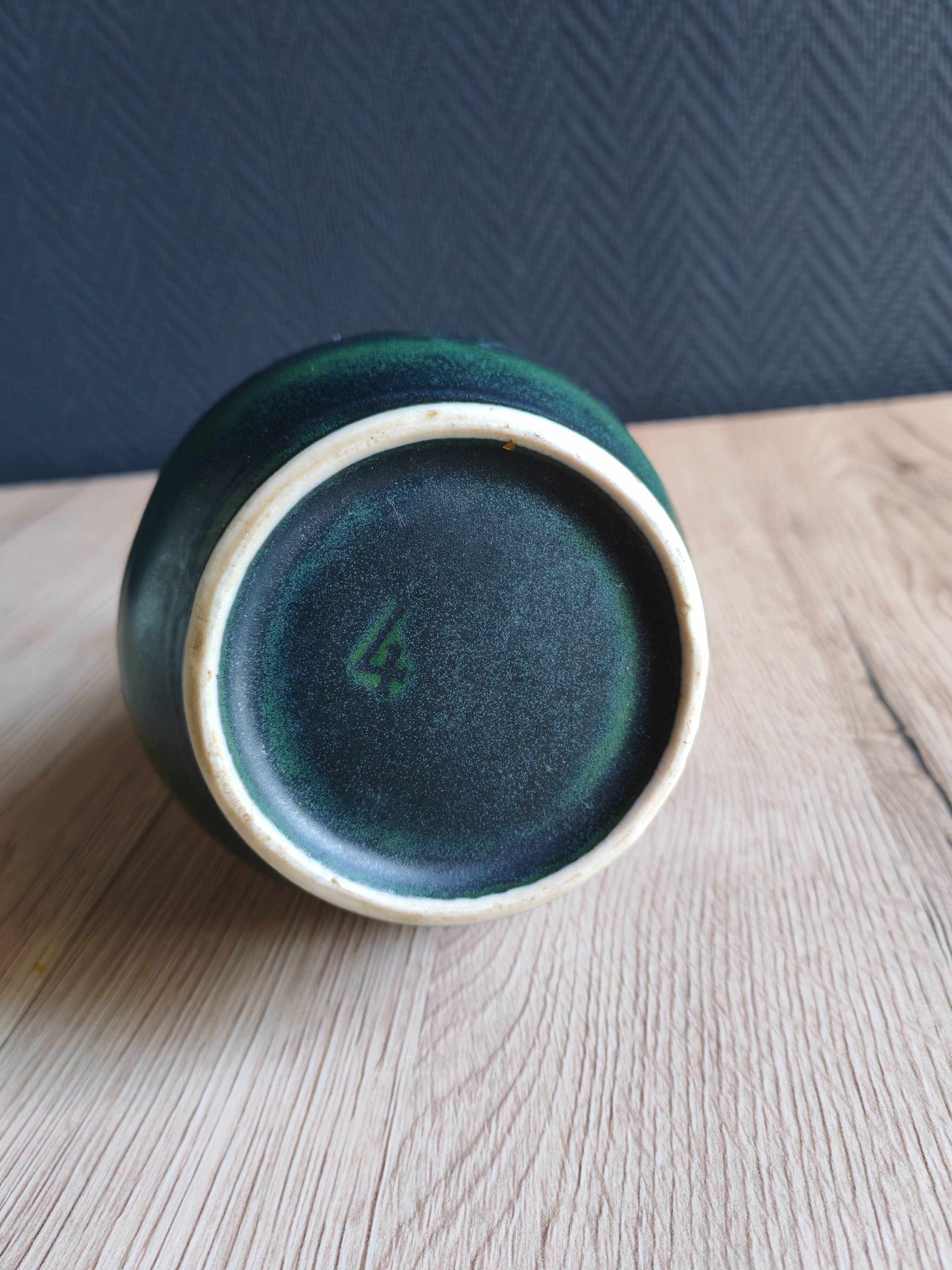 Vintage ceramic pitcher vase in glazed green and blue.