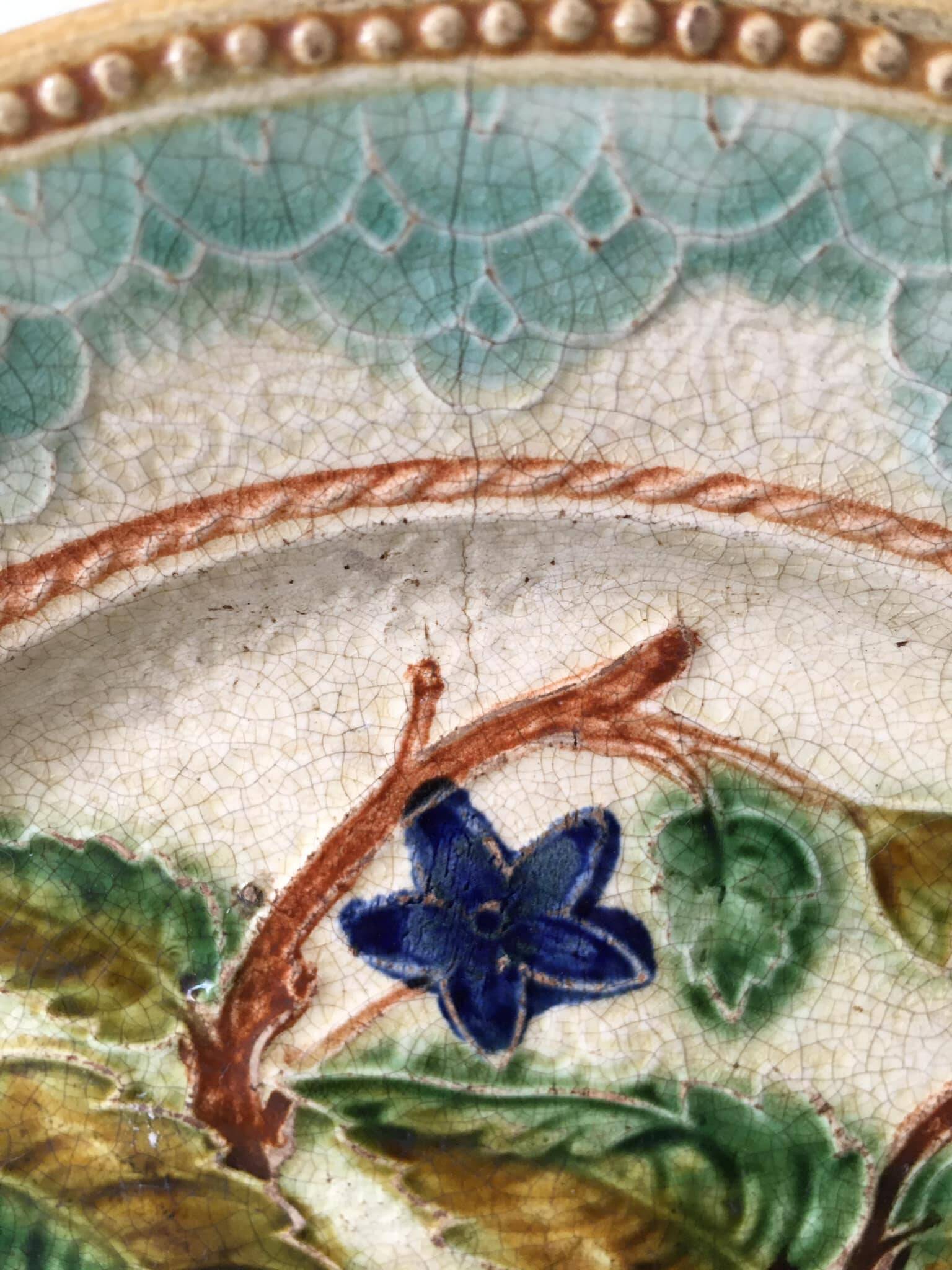 Old barbotine dessert plate. Floral patterns