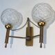 Pair of brass wall lights with glass globes. Around 1970.