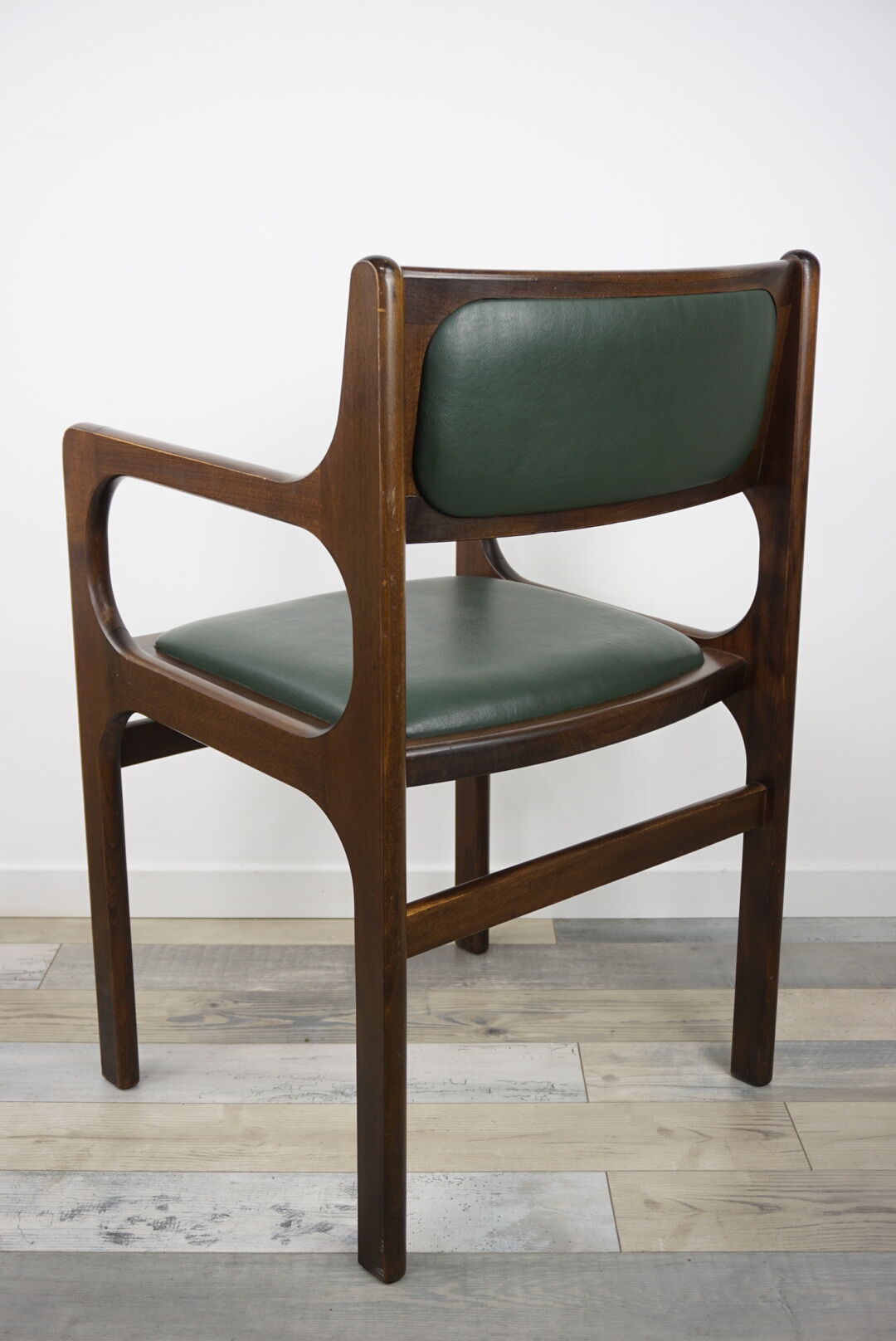 Armchair of the 60s in wood and imitation dark green leather