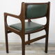 Armchair of the 60s in wood and imitation dark green leather