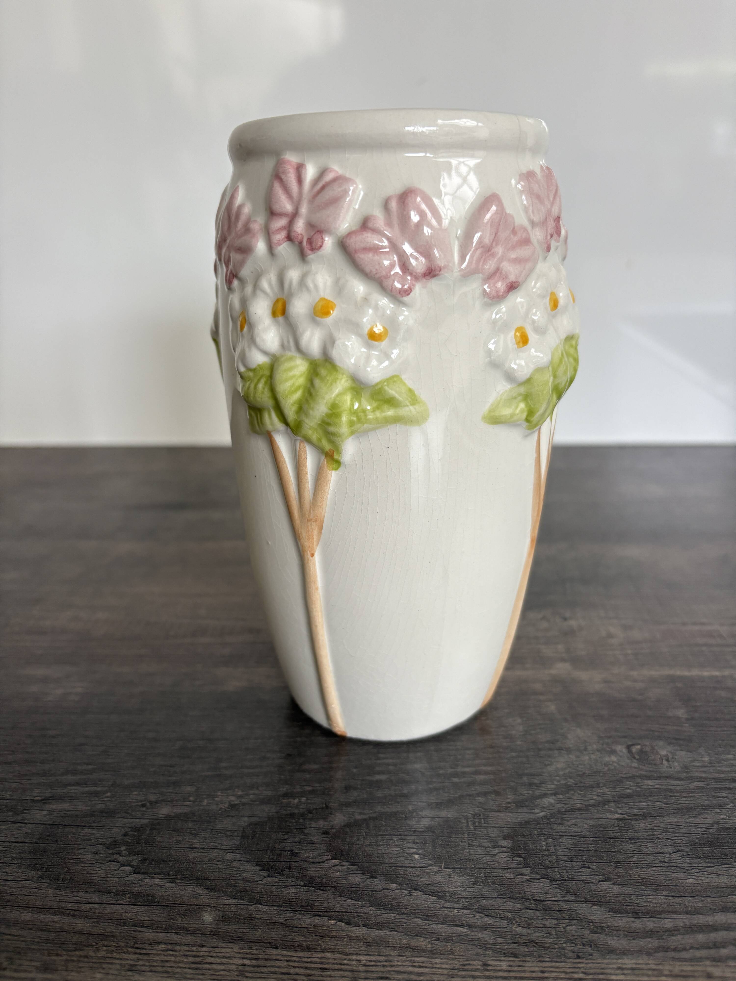 Antique ceramic vase with flowers and butterflies