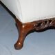 Three-seater canapé carved from solid walnut with claw feet.