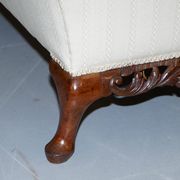 Three-seater canapé carved from solid walnut with claw feet.