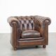 Cowhide English Chesterfield armchair with ball legs and timeless finish