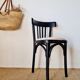 Curved black wooden bistro chair with striped seat