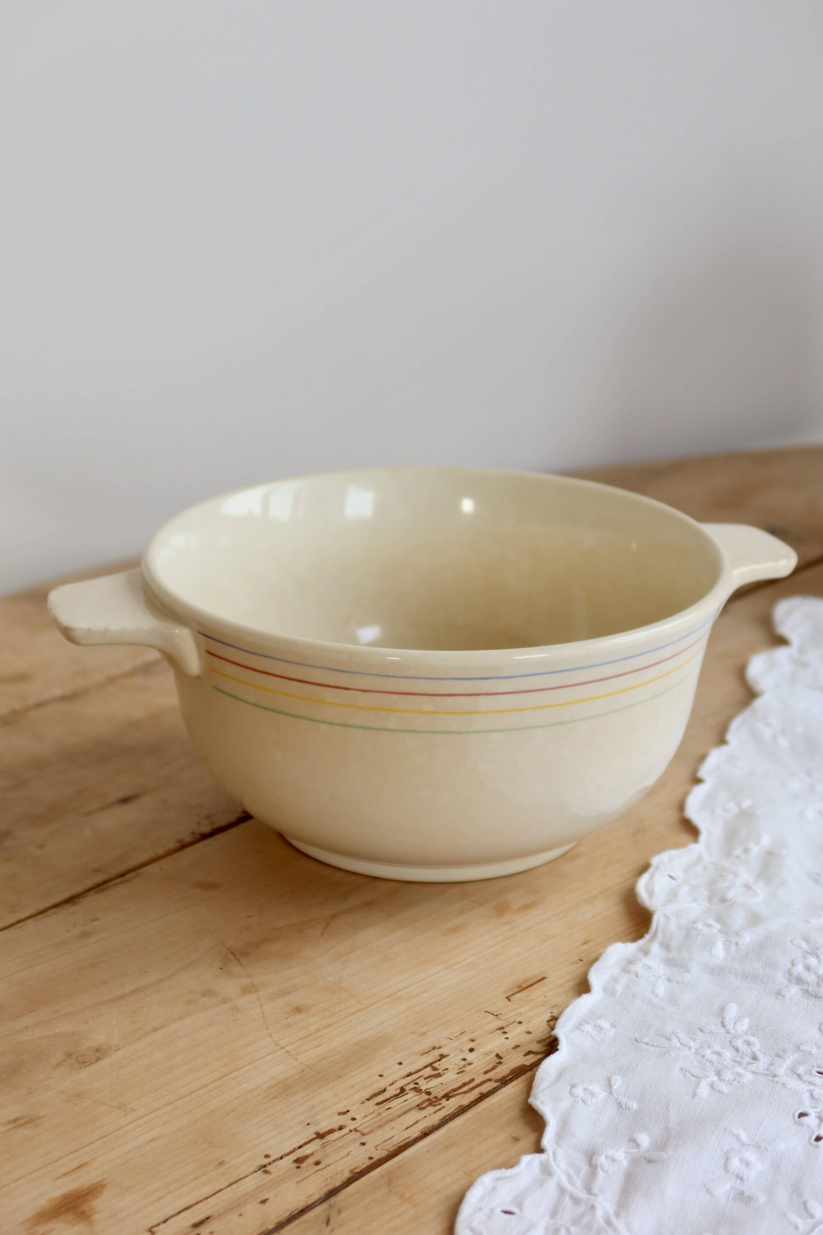 Vintage salad bowl in ivory faience from Chantilly with a rainbow trim.