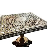 Antique cast iron garden table with decorative openwork top.