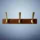 Vintage wooden wall-mounted coat rack with 3 golden cast aluminum hooks