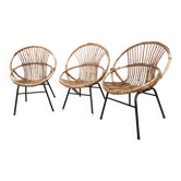 Trio of vintage rattan shell armchairs with metal legs, antique wicker seating furniture