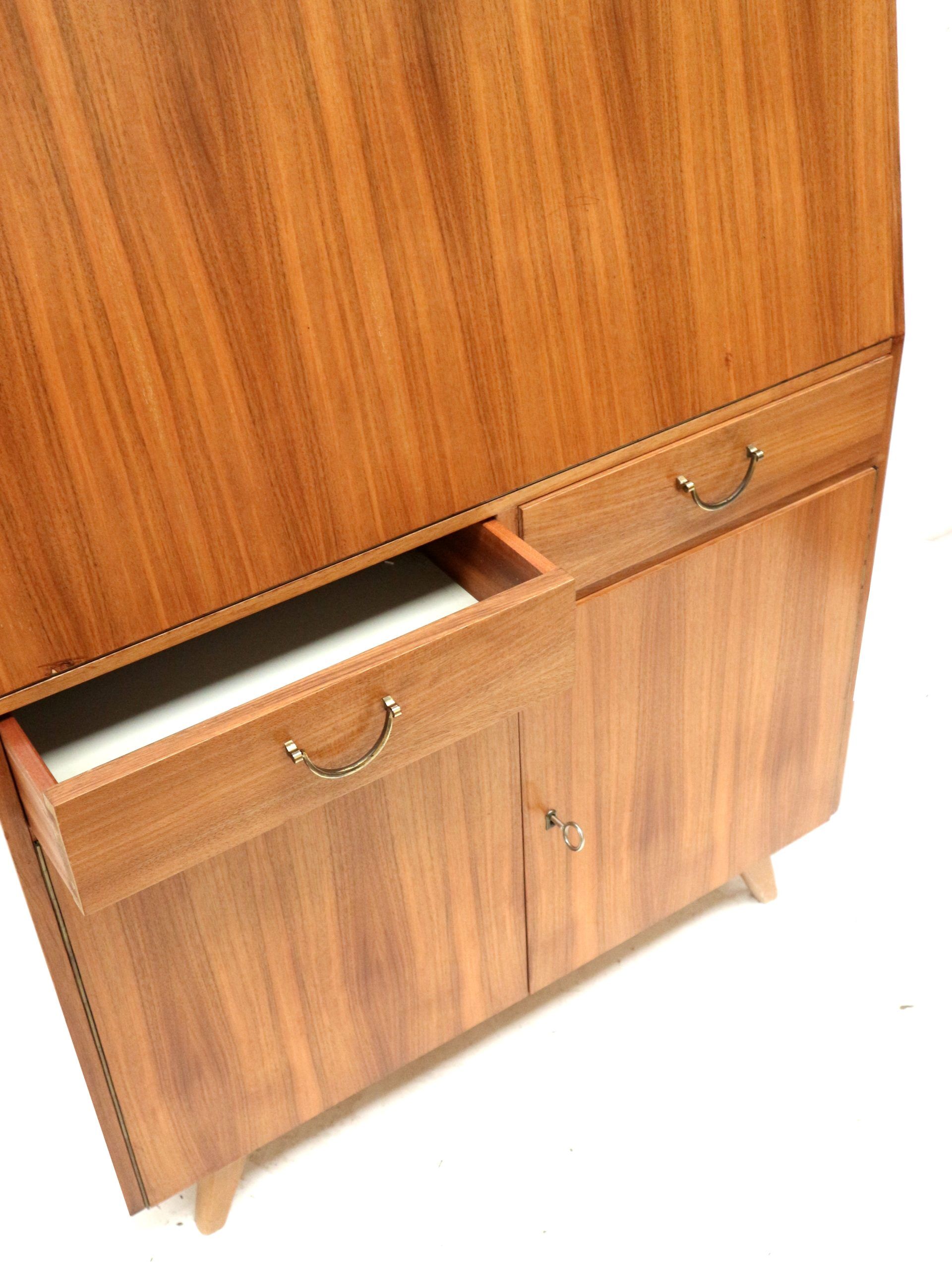 Vintage secretary with drawers, drop-down and doors from the 1960s.