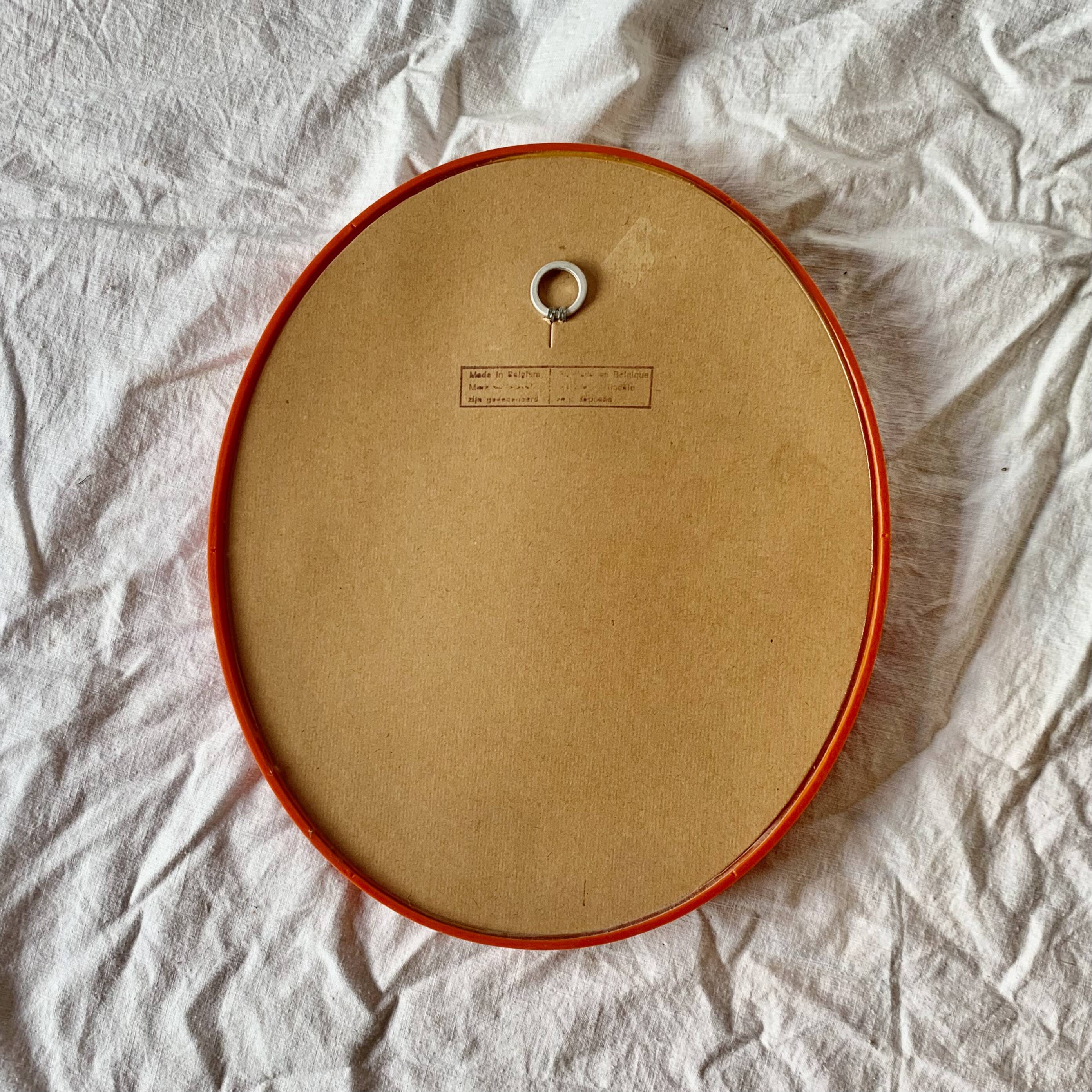 Vintage orange plastic oval wall mirror