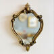 Small antique mirror in baroque style – gold frame in bronze or brass.