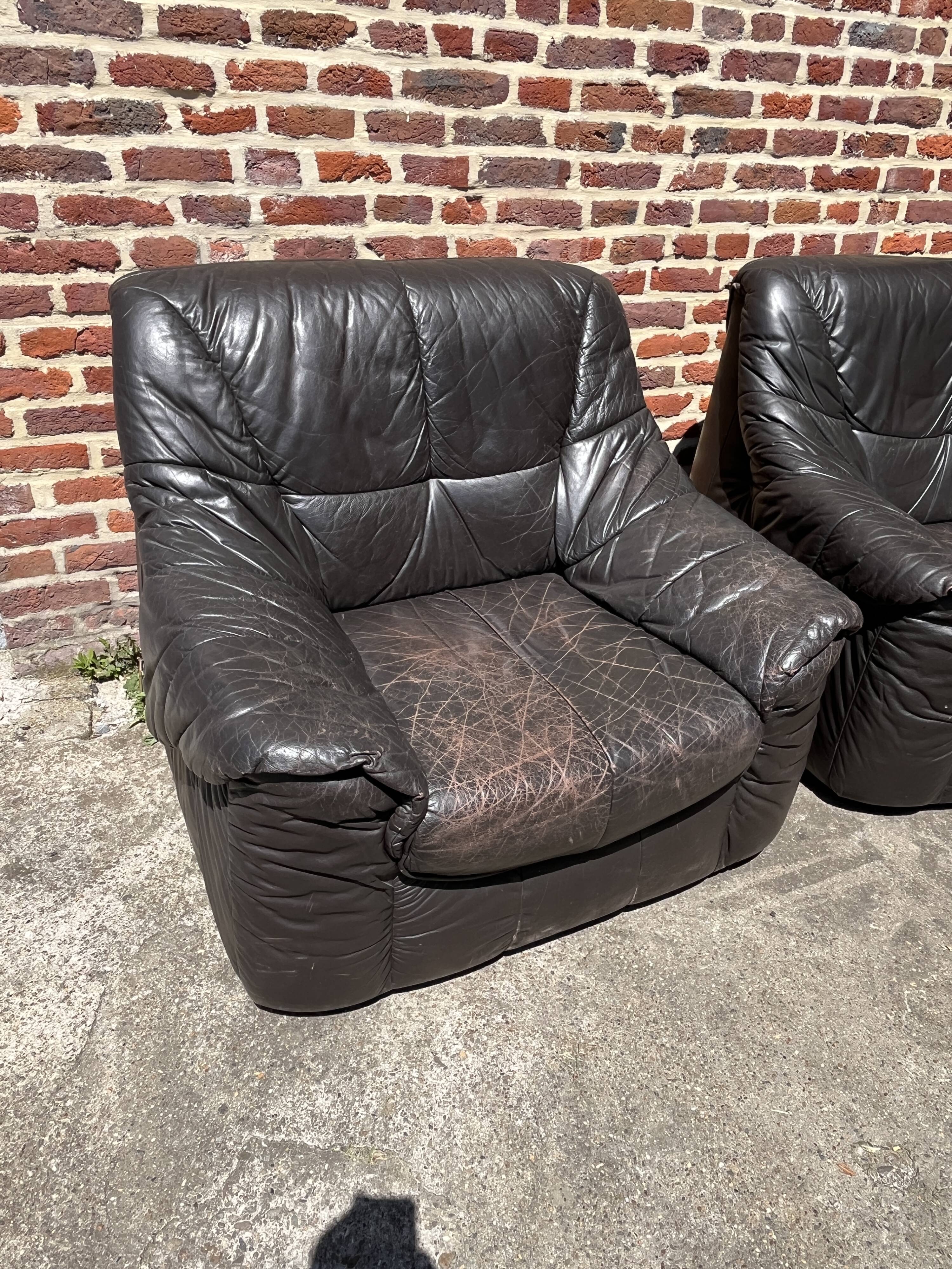 Pair of patinated leather club armchairs