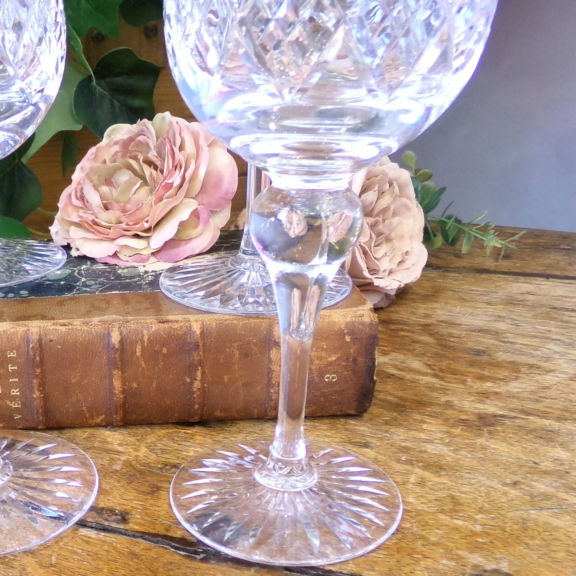 4 lead crystal wine glasses with slender baluster stems.