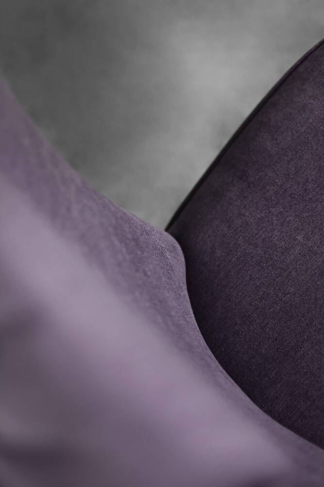 High-backed wing chair in oak and purple fabric, vintage Scandinavian style from the 1950s.