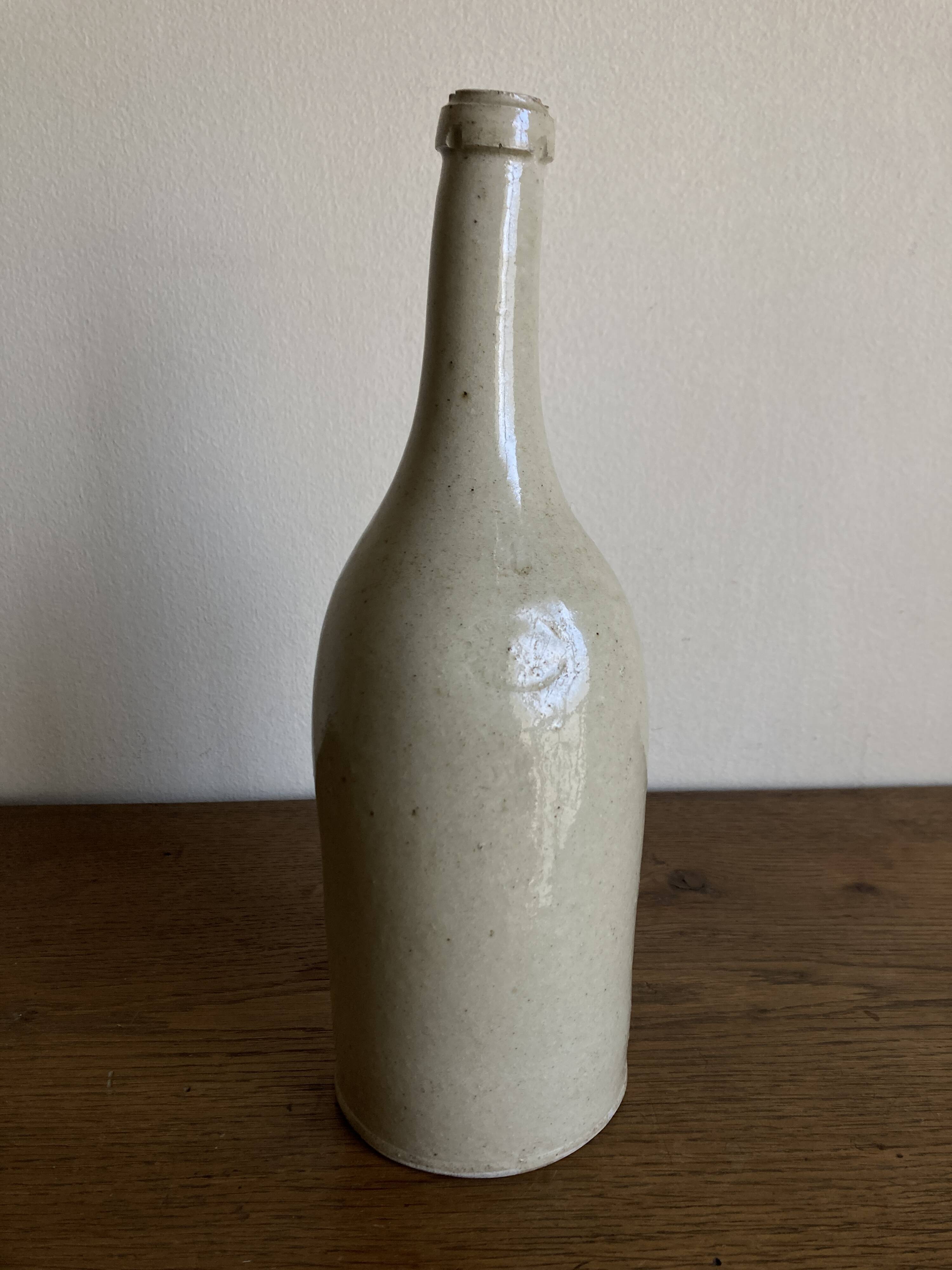 Stoneware bottle tilted at an angle, early 20th century