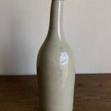 Stoneware bottle tilted at an angle, early 20th century